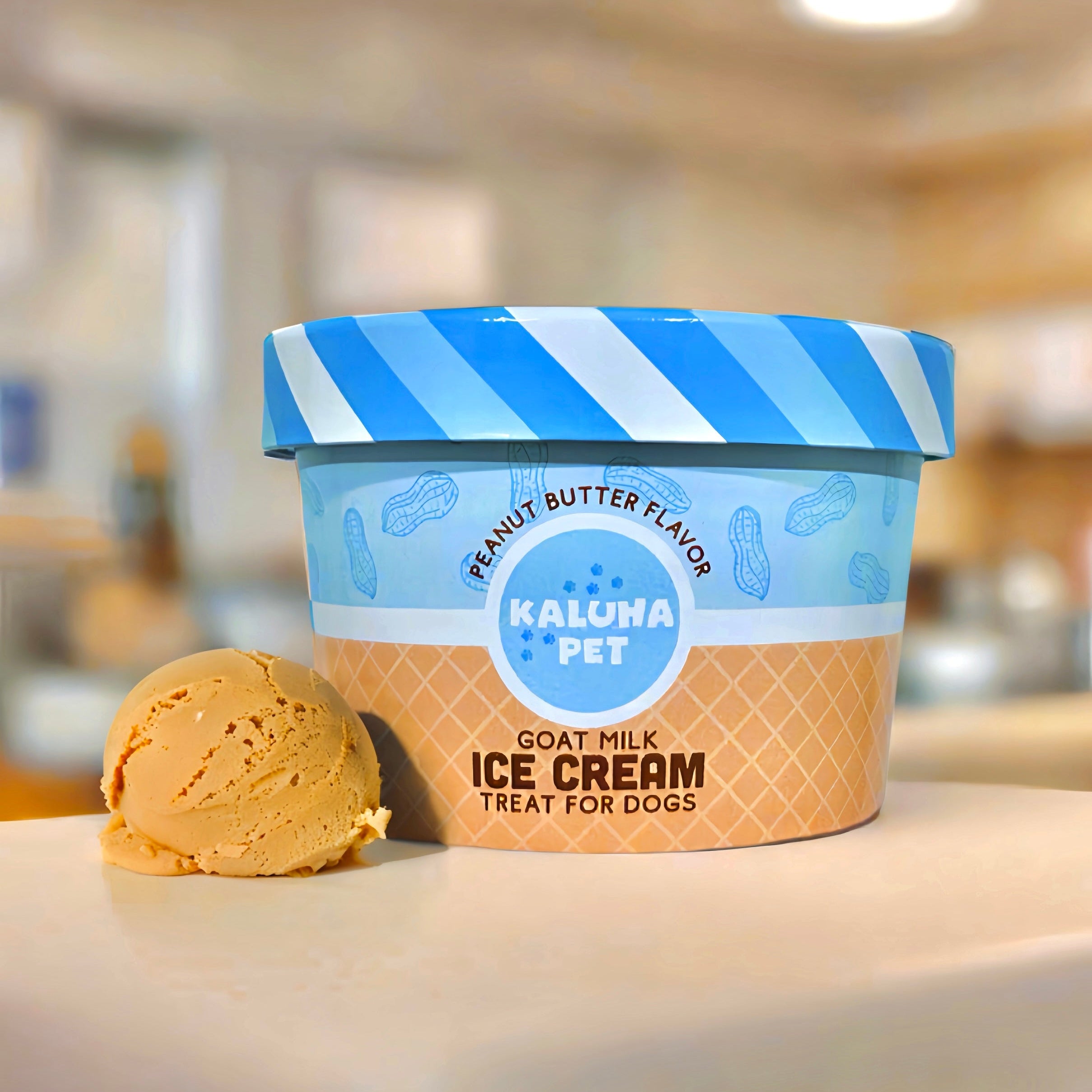 Peanut Butter Dog Ice Cream Mix, showing an ice cream cup with a scoop of tan ice cream to the side of it